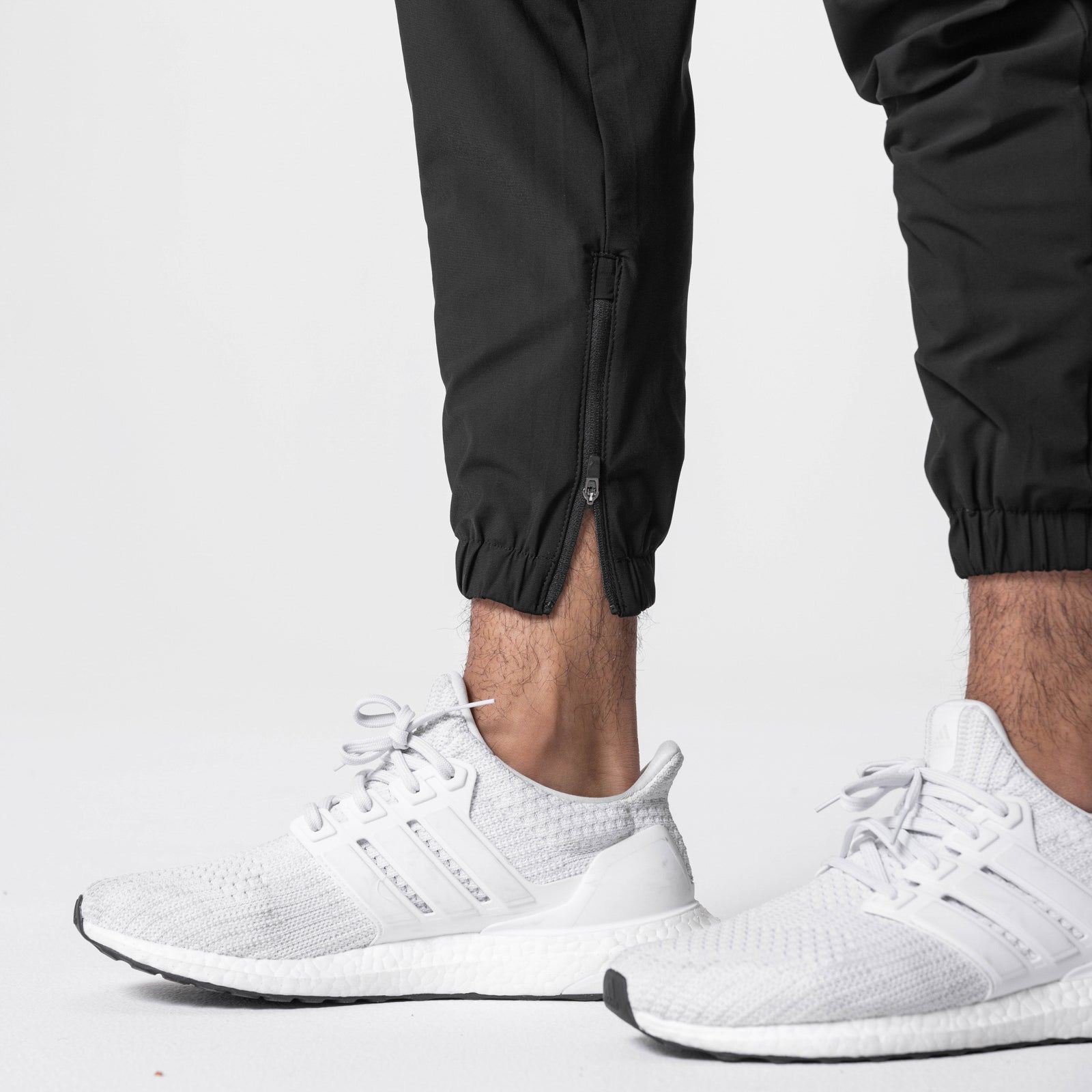 Tetra-Lite Standard Zip Jogger in black, worn with white sneakers, cropped leg view