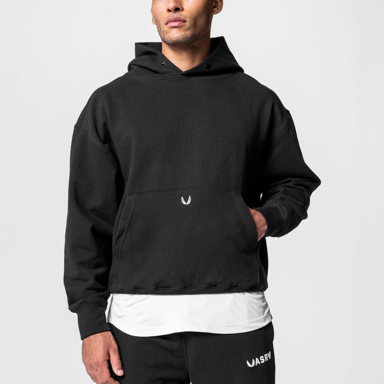 Black Tech-Terry™ hoodie worn by model, layered over white undershirt, front view