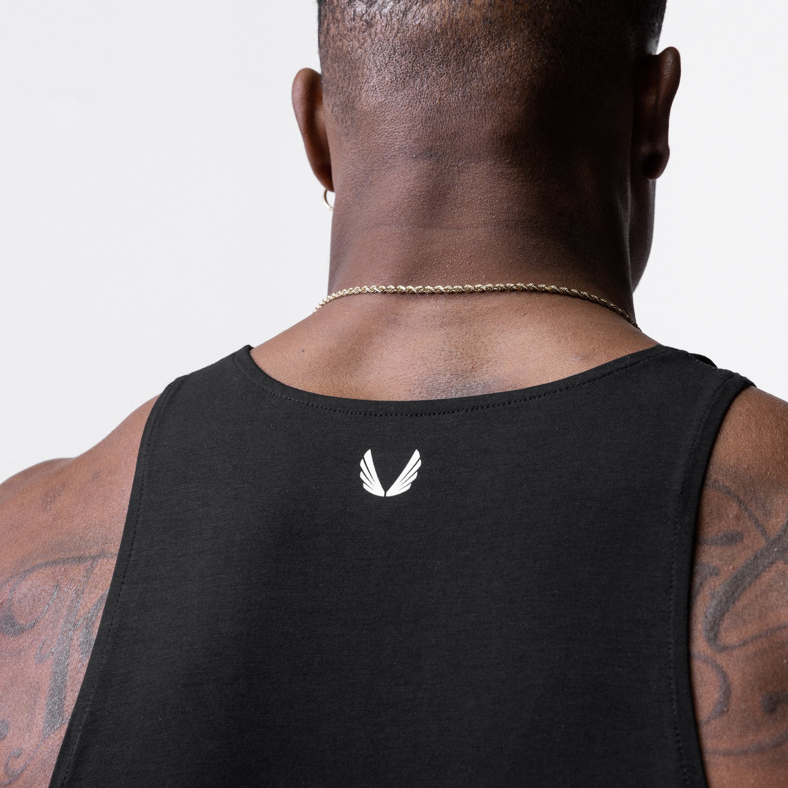 Solucell™ Essential Slim Tank in black, rear view on model with tattoos