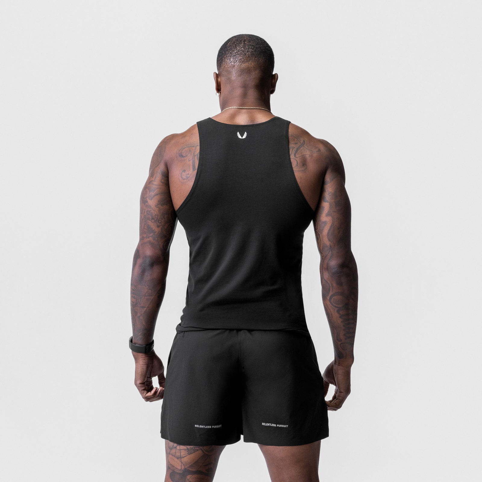 Solucell Essential Slim Tank in black, rear view on model showing tattoos and athletic build