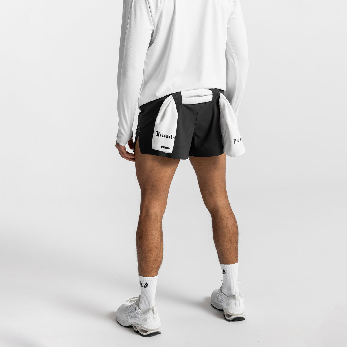 Tetra-Lite Laser Cut 3" Short in black and white colorblock, modeled with long sleeve top and white socks