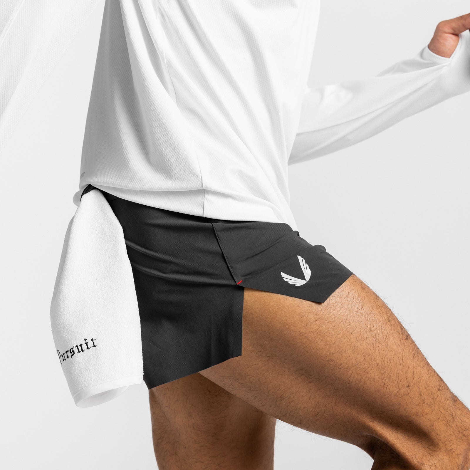 Tetra-Lite Laser Cut 3" shorts in black, modeled with white long-sleeve shirt