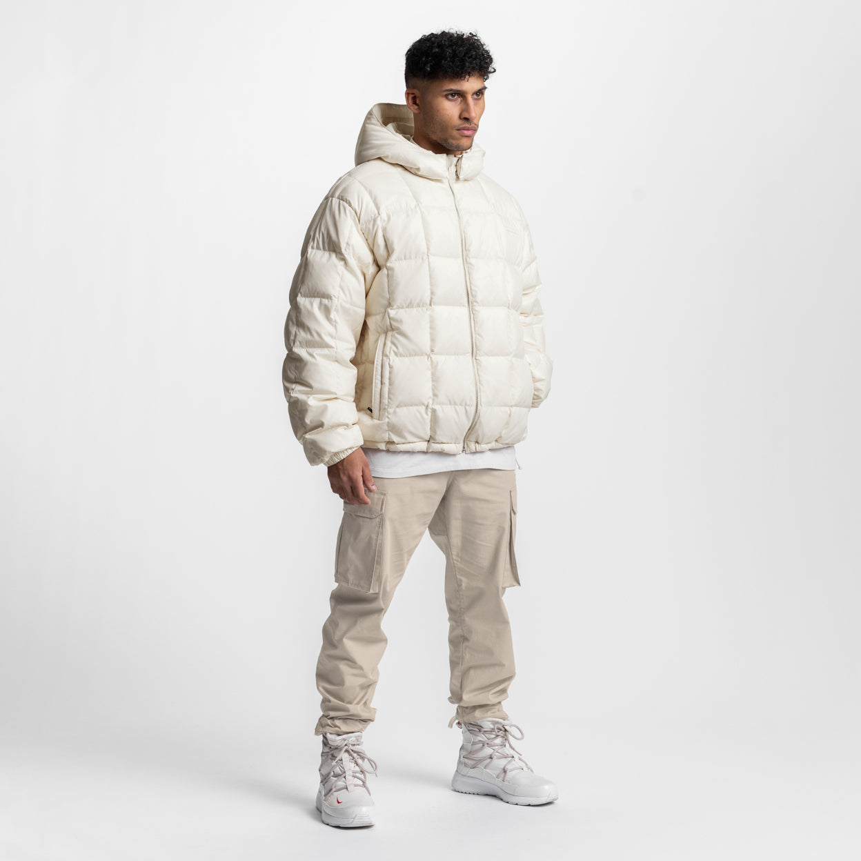 Weather-Ready Down Puffer Jacket in ivory cream, worn by model with beige pants and white sneakers