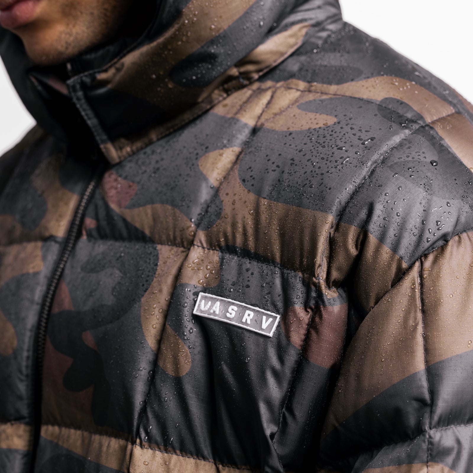 Weather-Ready Down Puffer Jacket in rust camo worn by model, wet fabric detail