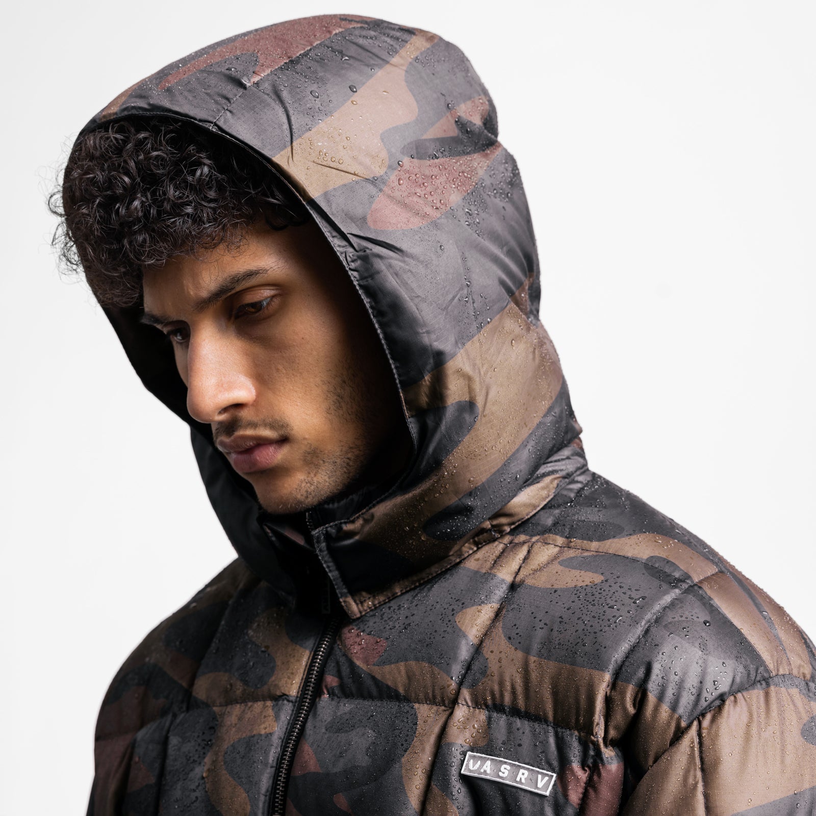 Weather-Ready Down Puffer Jacket in rust camo, worn by model in profile with hood up