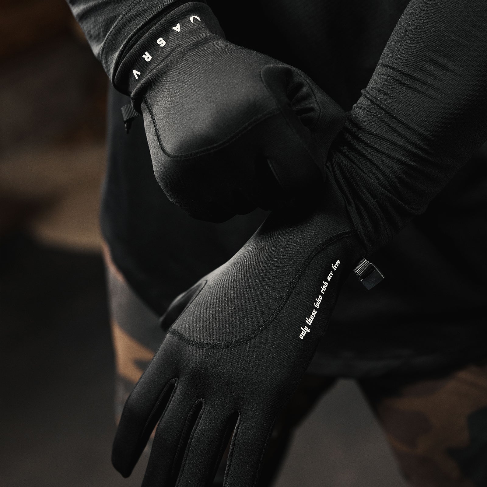 Aeroheat® Lightweight Gloves in black, worn on model's hands with wrist cuff detail visible