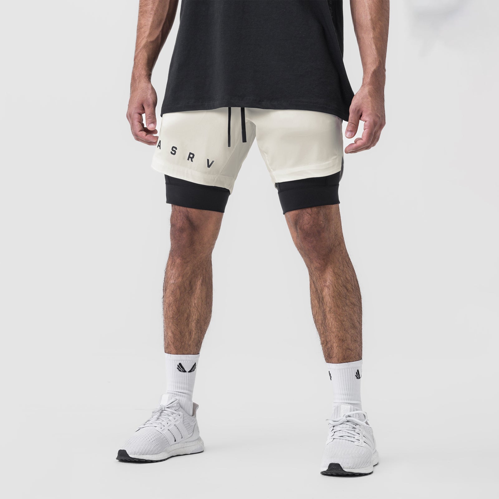 Tetra-Lite 7" Liner Short in Stone and Black, worn by model with white sneakers, front view