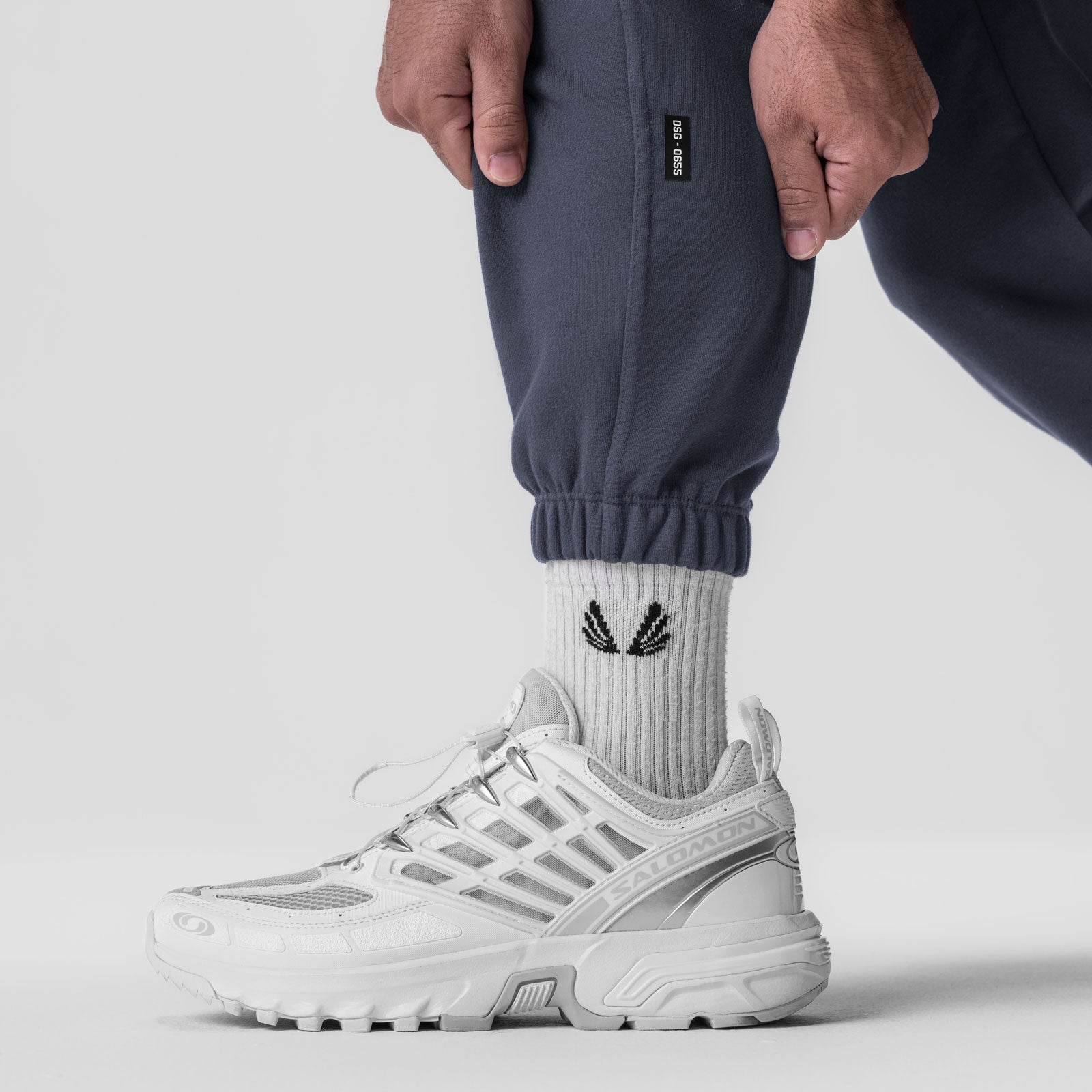 Navy Tech-Terry Oversized Sweats worn with white socks and sneakers, detail shot of ankle and lower leg