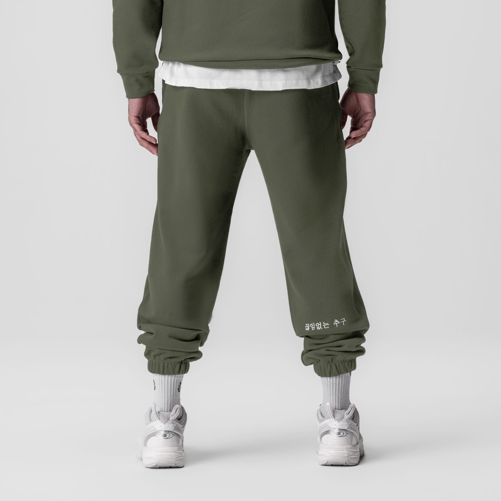 Tech-Terry Oversized Sweats joggers in olive, back view on model with white socks and sneakers