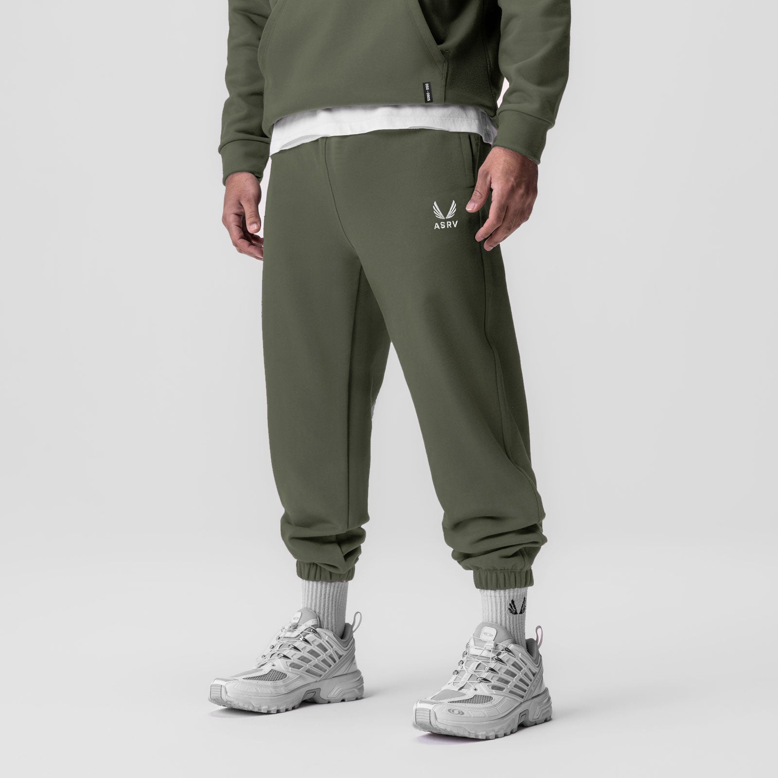 Tech-Terry Oversized Sweats joggers in olive, worn with white sneakers and socks, front view