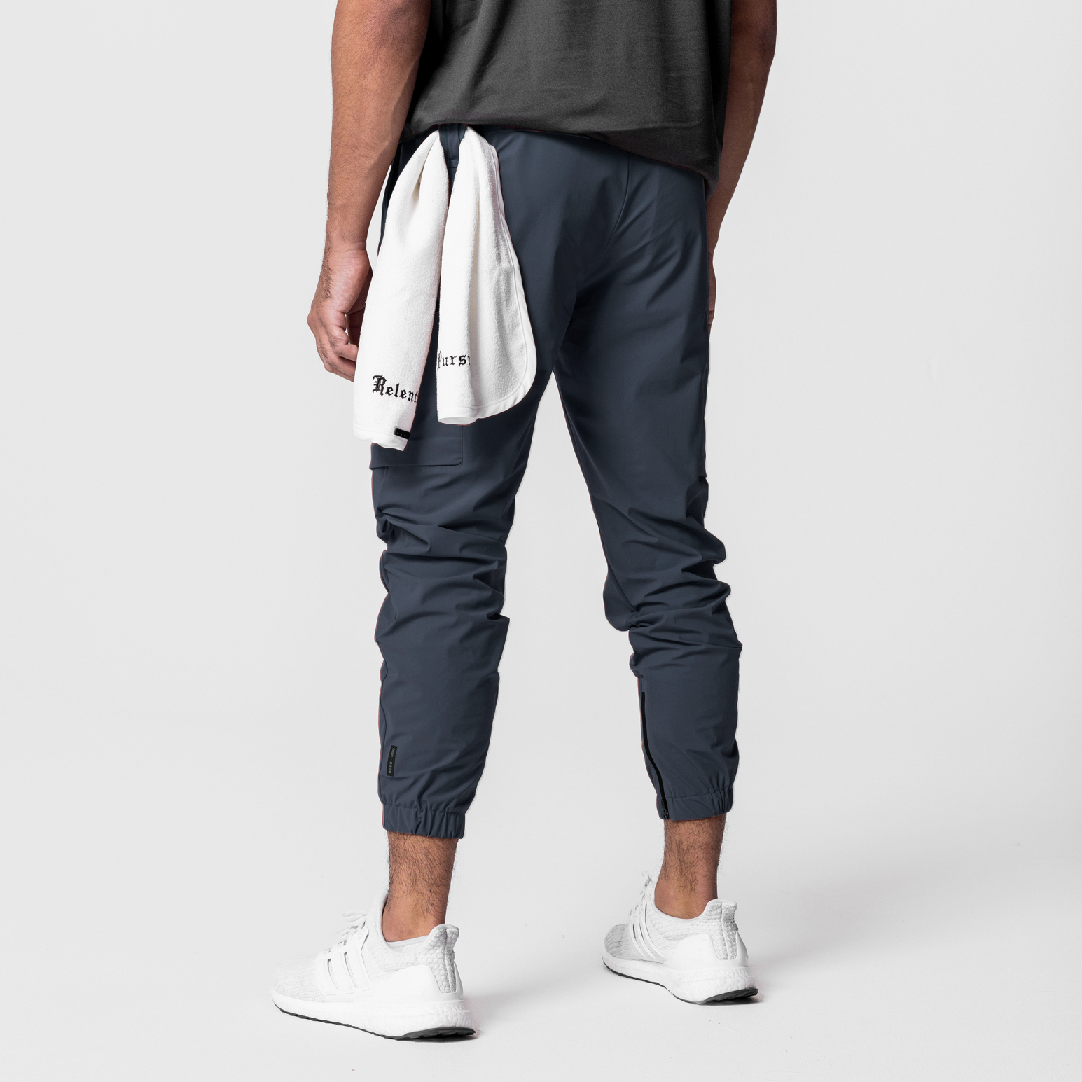 Tetra-Lite Standard Zip Jogger in navy worn by model, back view with white towel