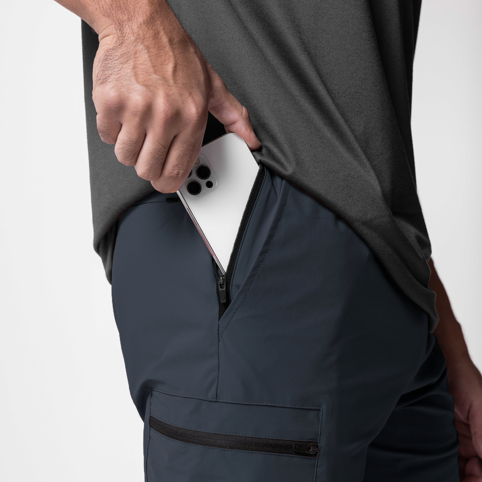Tetra-Lite Standard Zip Jogger in Navy, model holding phone in front pocket