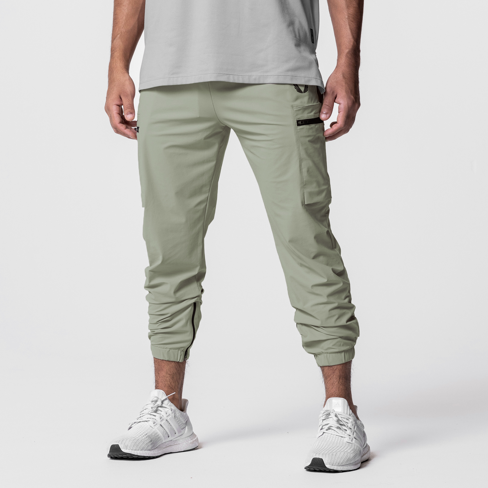 Tetra-Lite Standard Zip Jogger in sage, worn with white sneakers, front view
