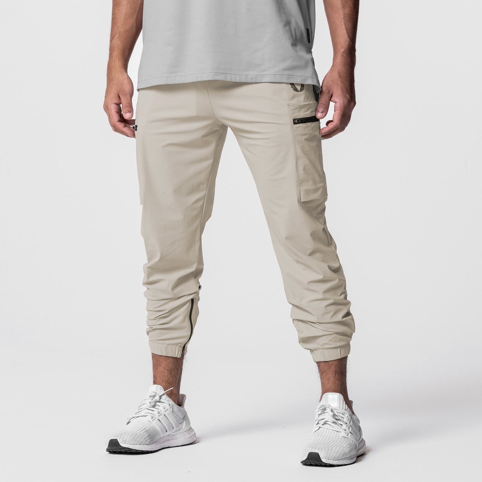 Tetra-Lite Standard Zip Jogger in sand, worn by model with white sneakers, front view