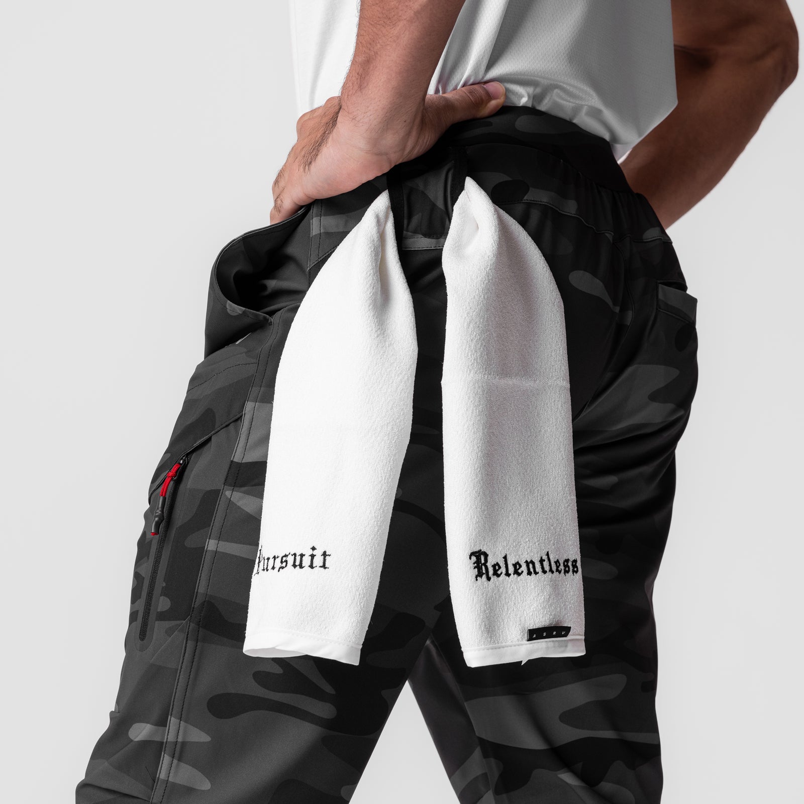 Tetra-Lite® Tech High Rib Jogger in black camo, worn by model holding white towel with text