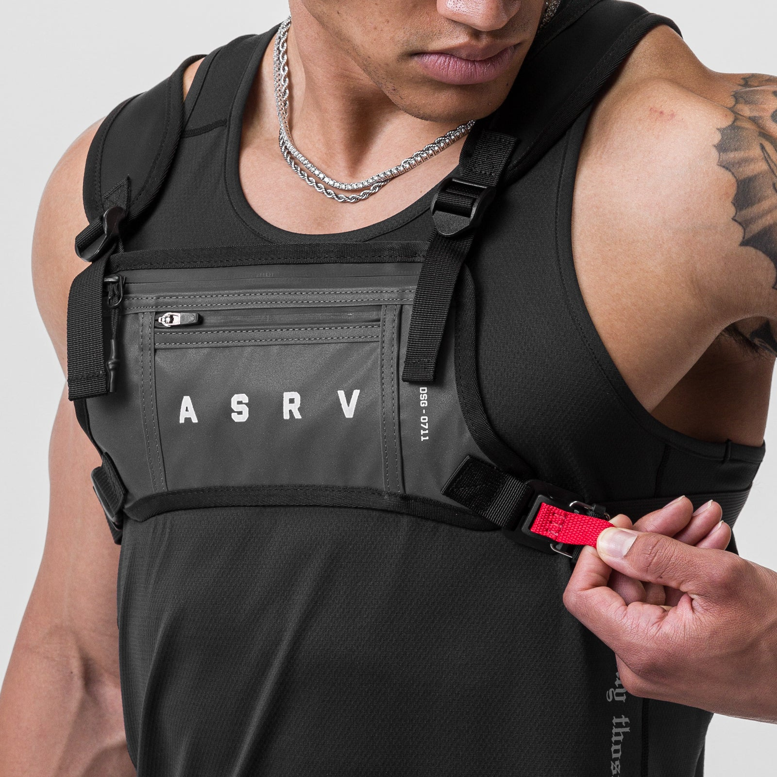 0711 Cordura Lightweight Chest Pack in black, worn on model with red buckle detail