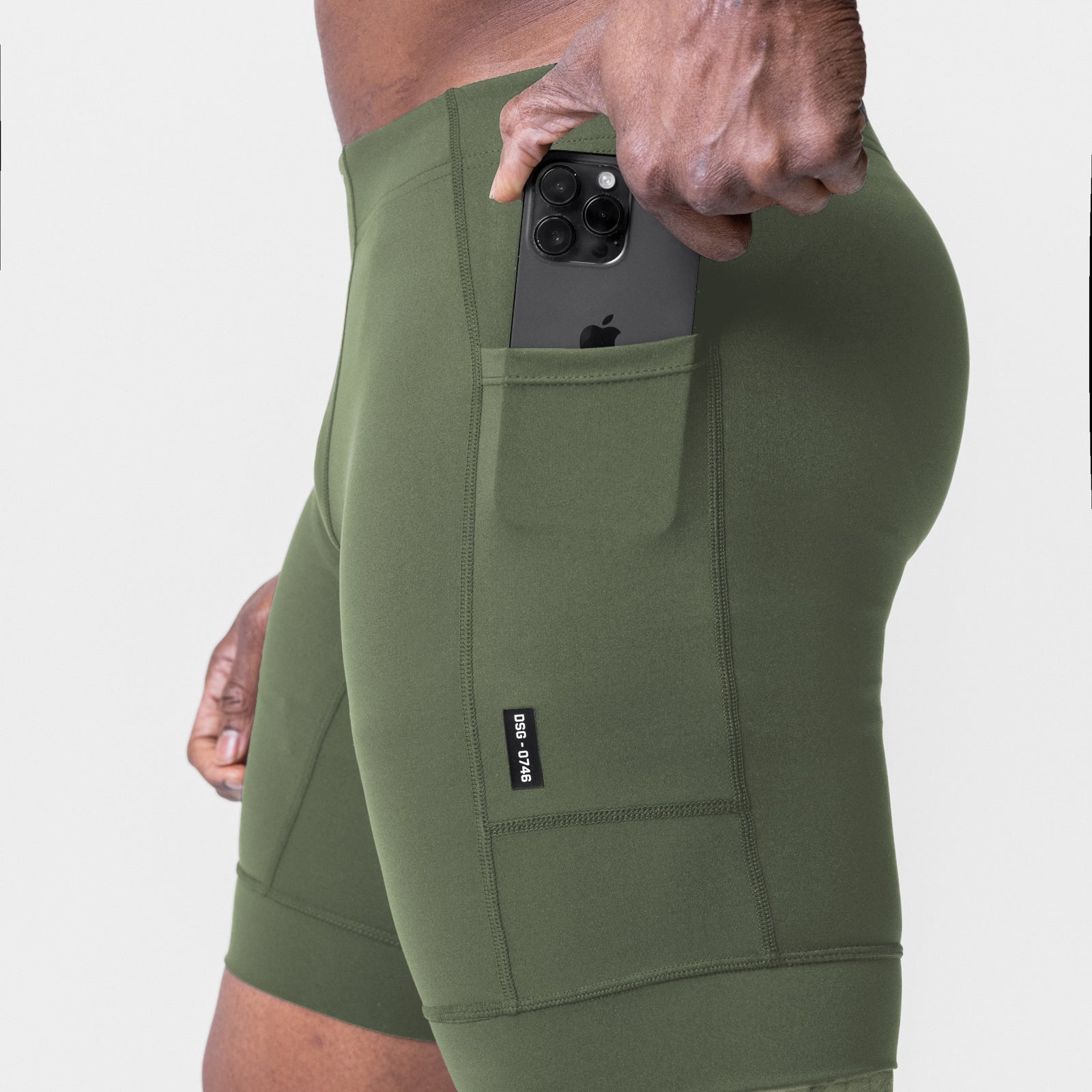 WarpFlexx® Side Pocket 1/2-Length Legging in olive, model holding phone in side pocket