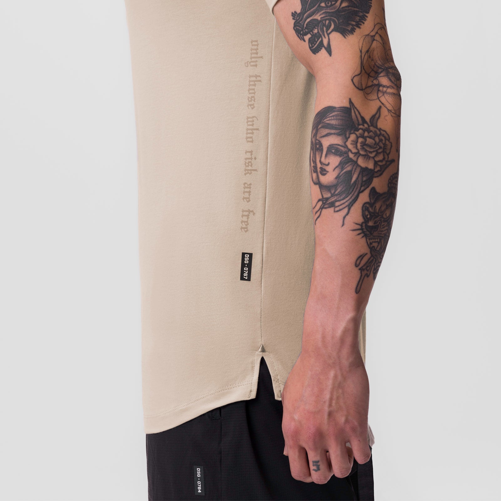 Beige Supima® Established Tee worn by model showing side view with tattoed arm