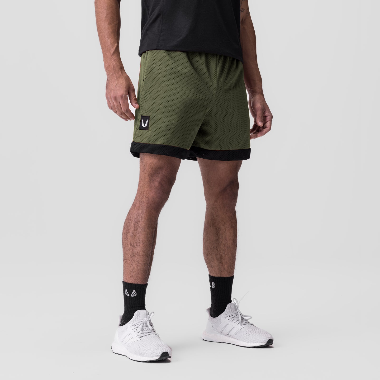 SilverPlus Mesh Reversible Short in olive and black, worn by model with white sneakers
