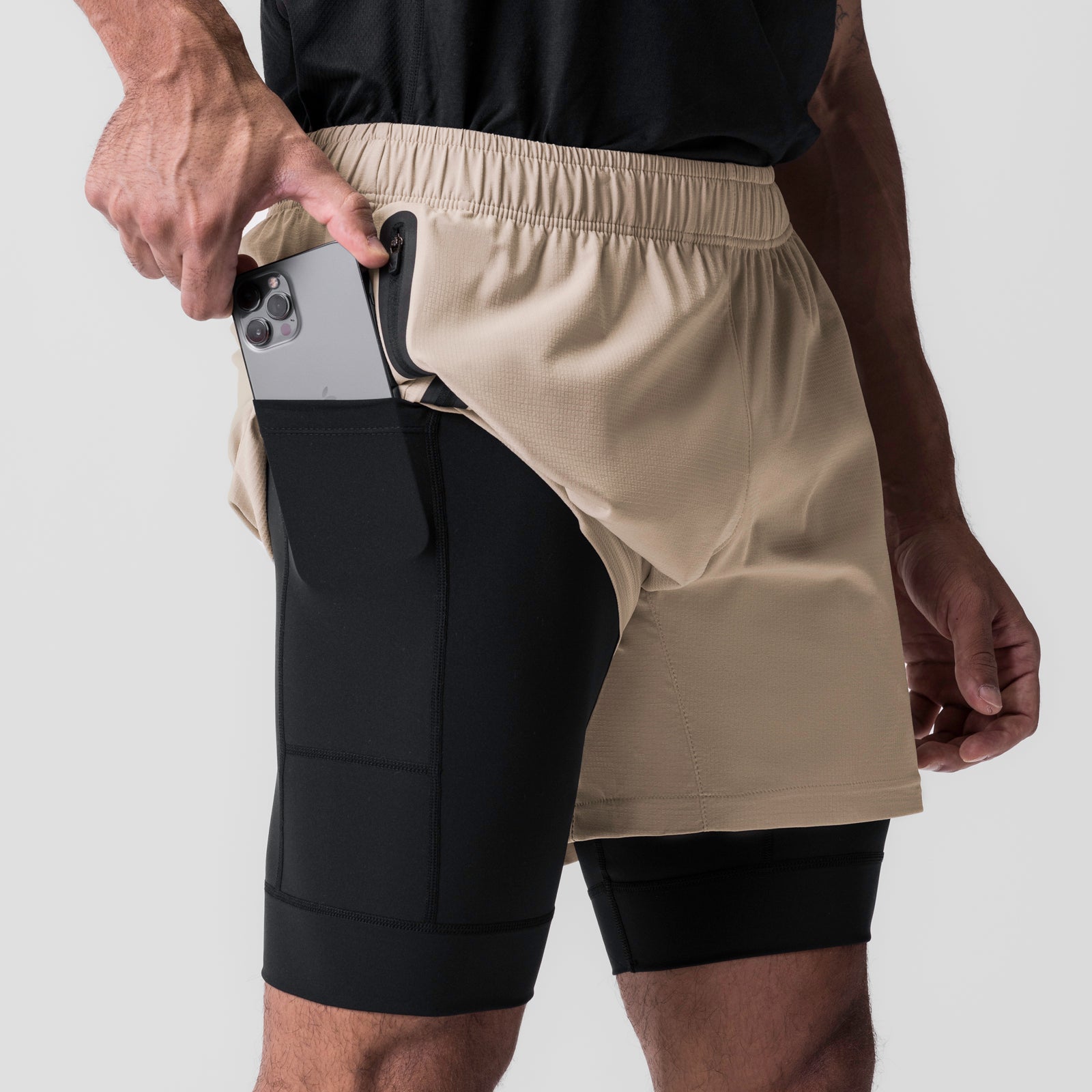 Ultralite™ 6" Liner Short in Beige/Black worn by model, demonstrating phone pocket functionality