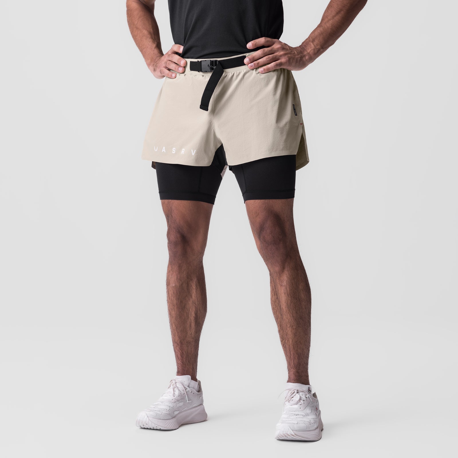 Ripstop 3" Belt Pack Short in beige and black, worn by model with black compression shorts