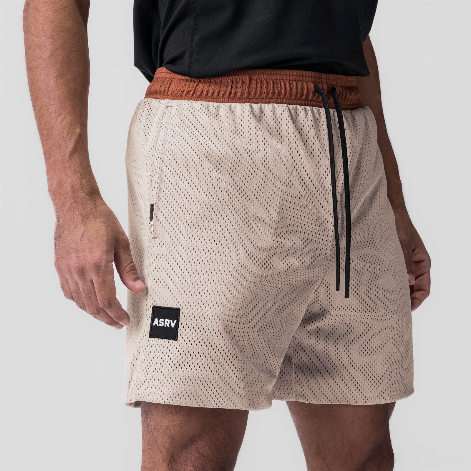 SilverPlus™ Mesh Reversible Shorts in rust and beige, worn by model, side view