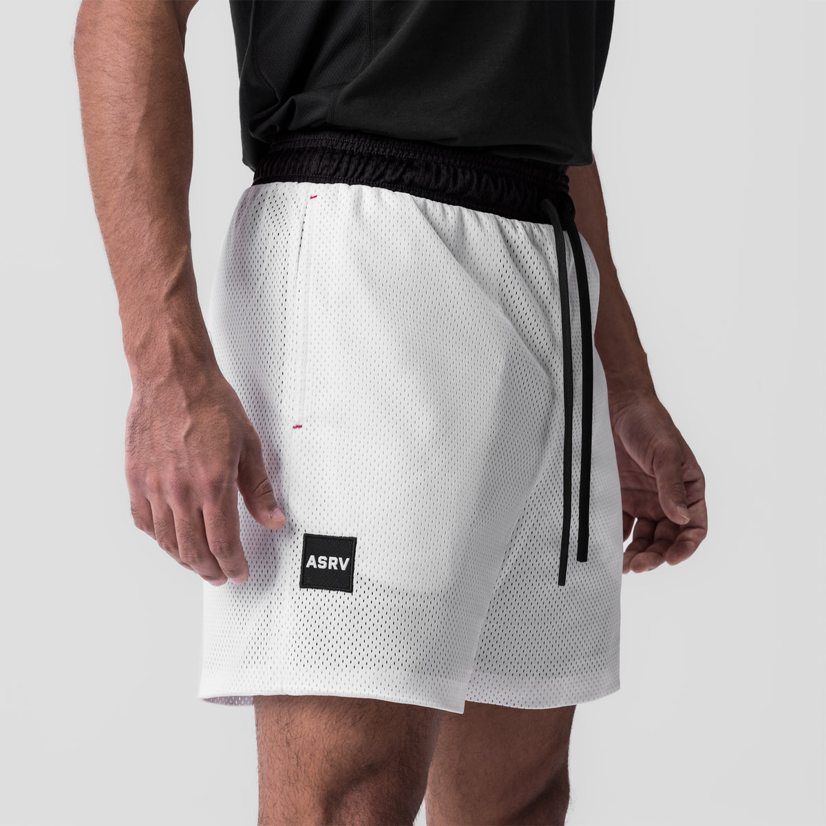 SilverPlus Mesh Reversible Short in white, worn by model, side view