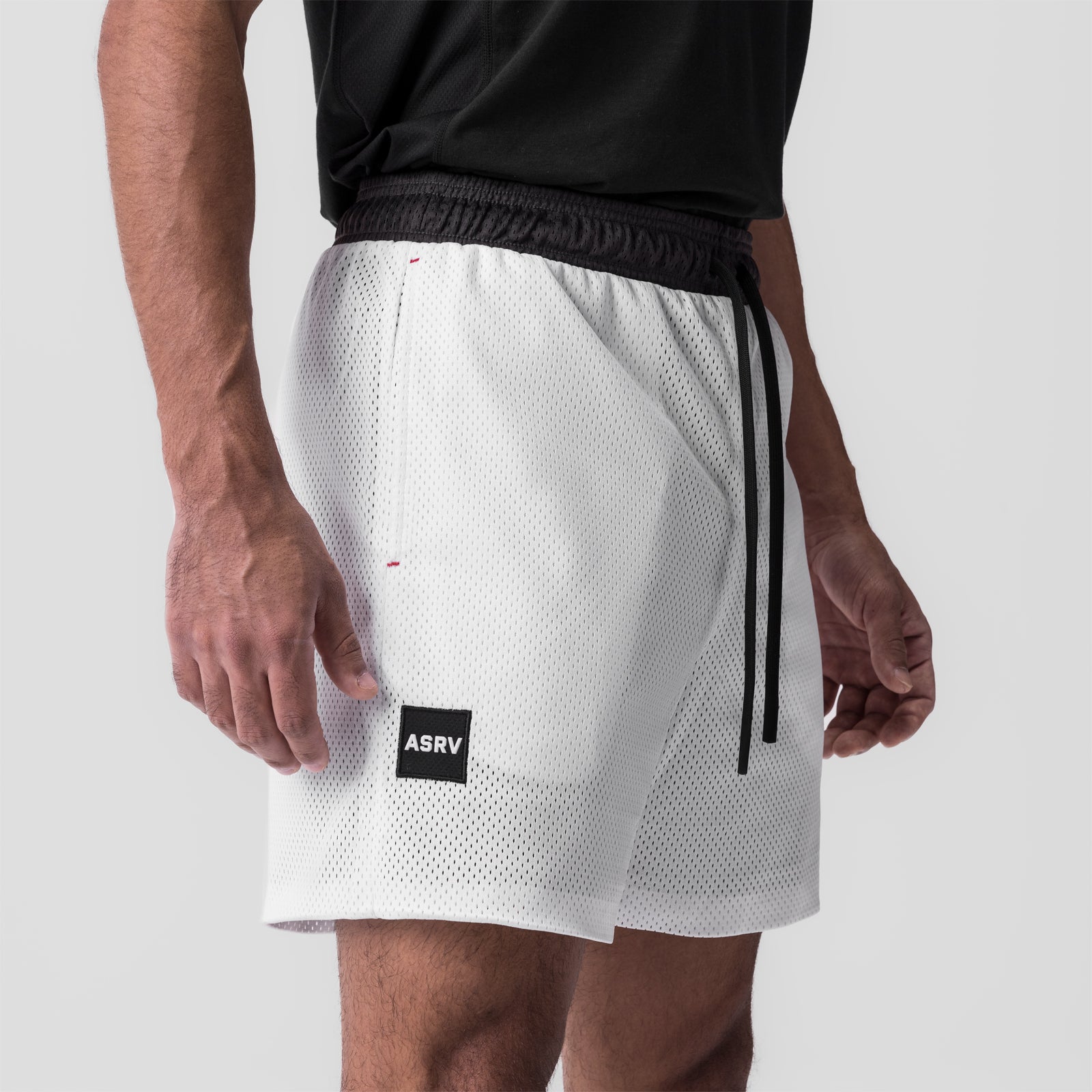 SilverPlus™ Mesh Reversible Short in white, worn by model, side view