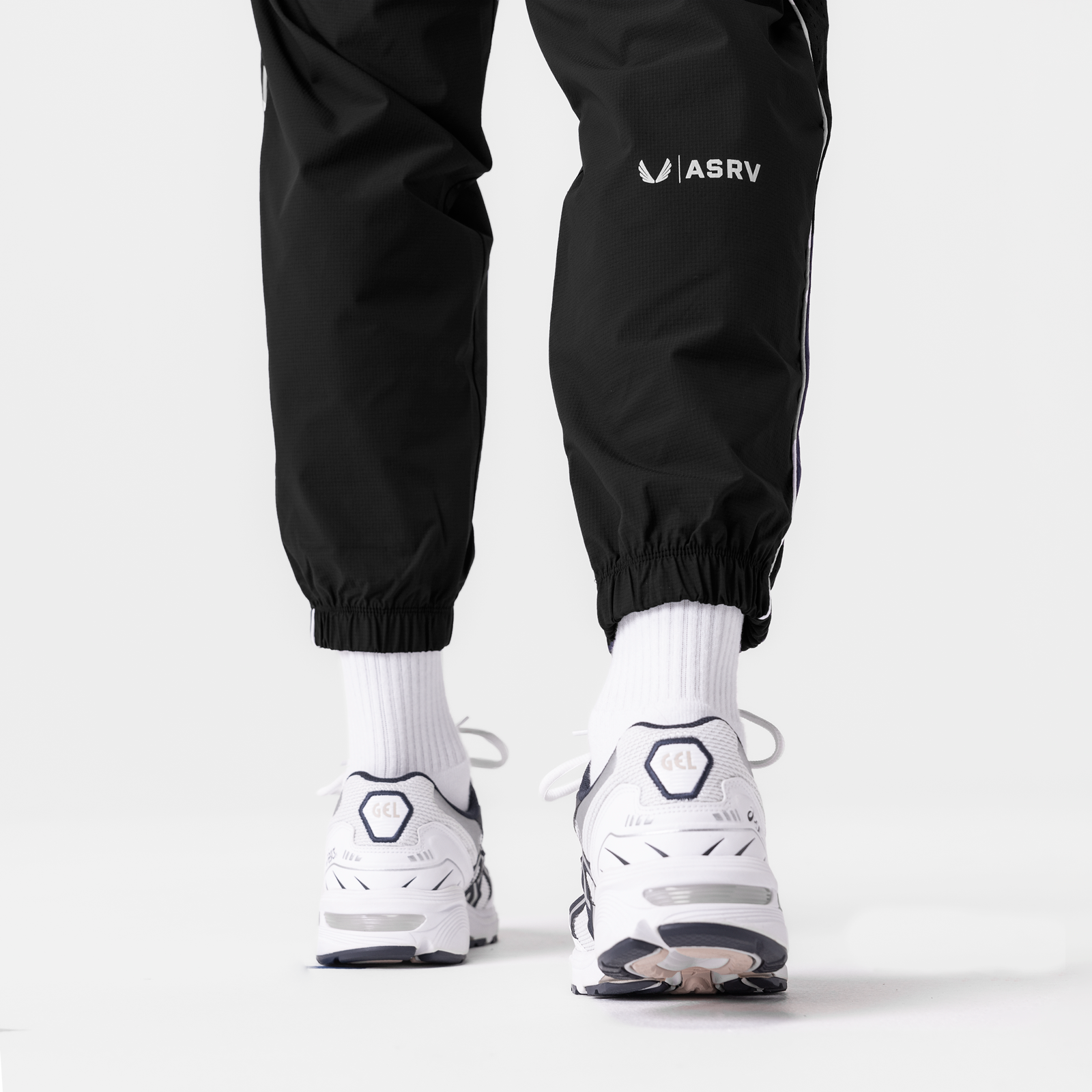 Black Ripstop Oversized Track Pant worn with white socks and sneakers, back view