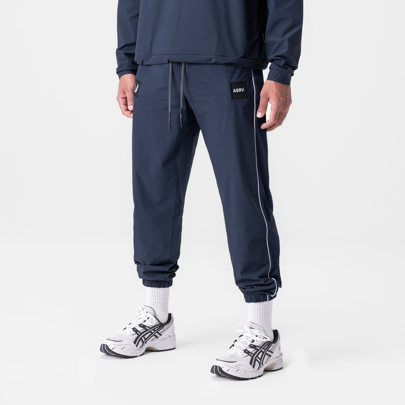Navy ripstop oversized track pant worn with white socks and sneakers, front view