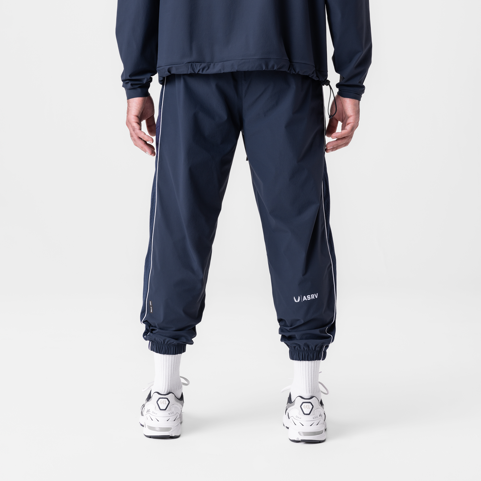 Navy ripstop oversized track pants with side stripe detail, back view on model