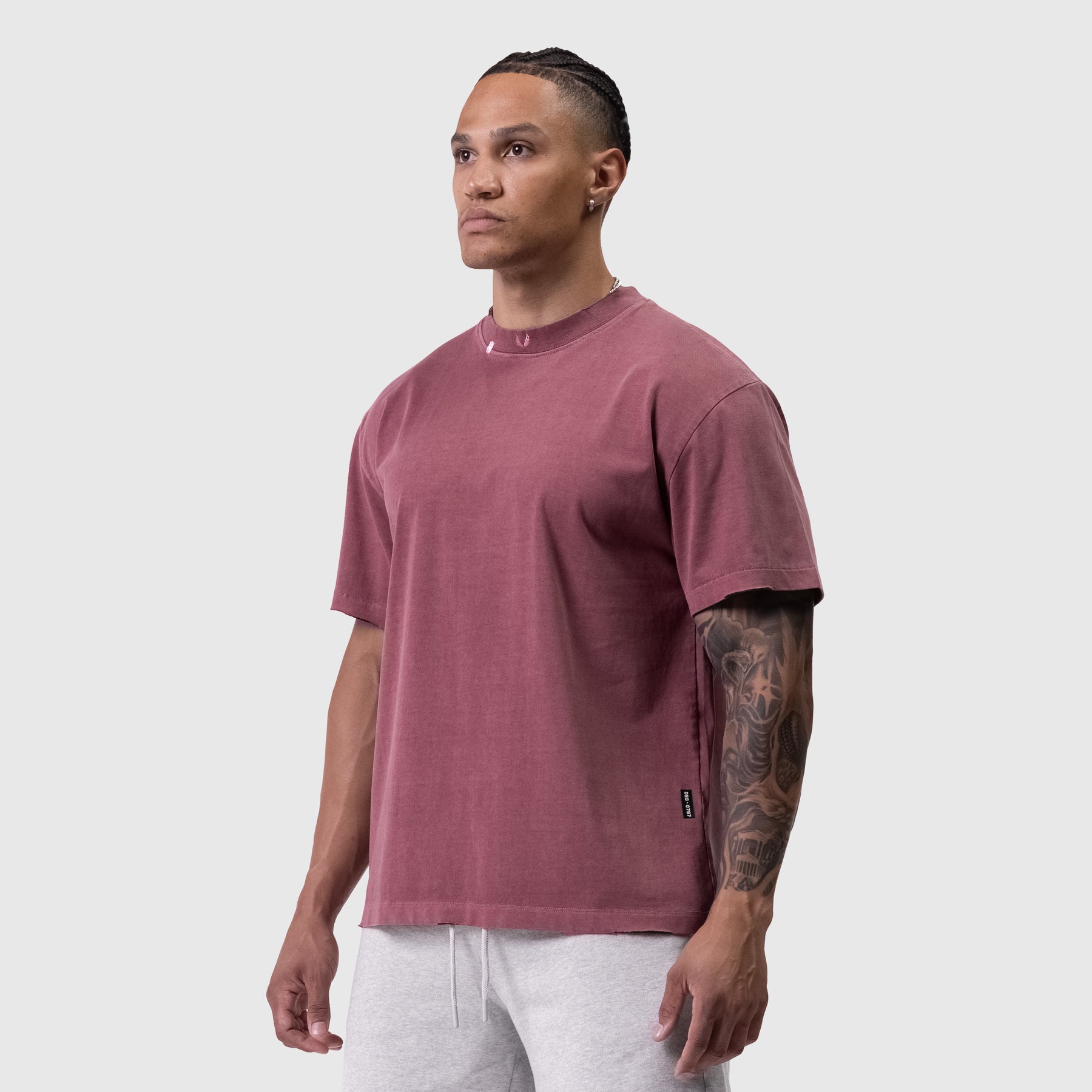 Tech Essential Relaxed Tee in faded crimson worn by male model, front view