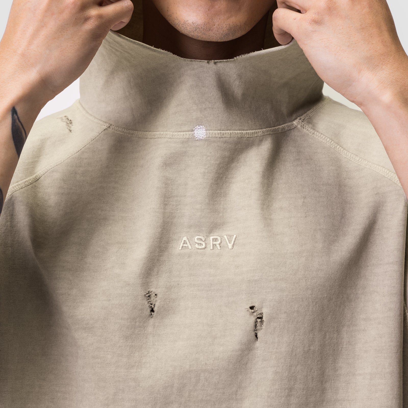 Tech Essential Cutoff Hoodie in faded beige worn by model, front view