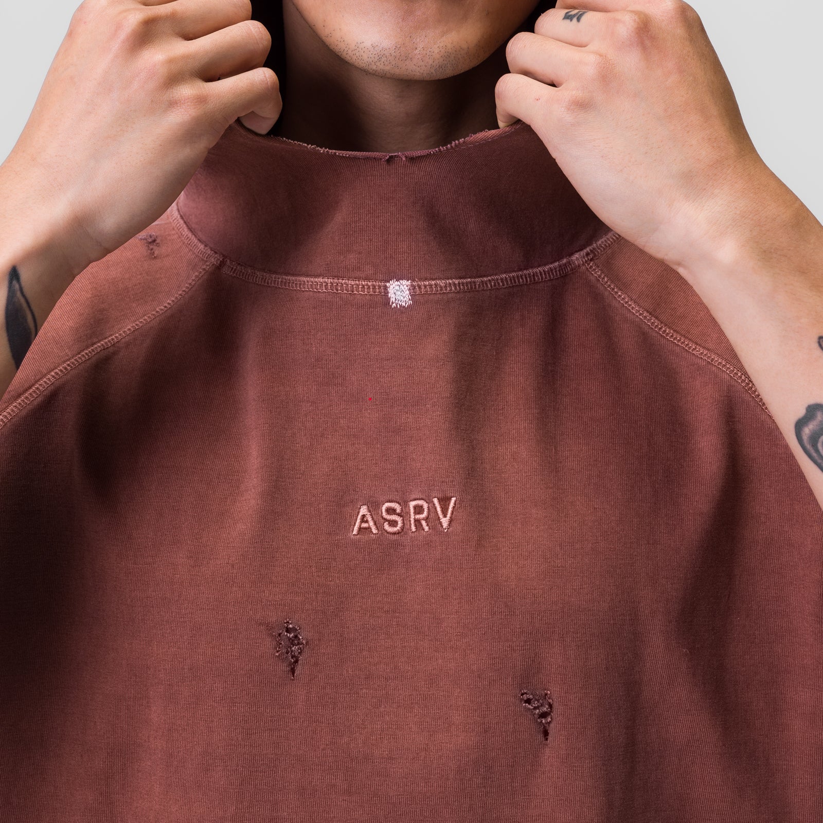 Tech Essential™ Cutoff Hoodie in faded brick, worn and pulled up at neckline