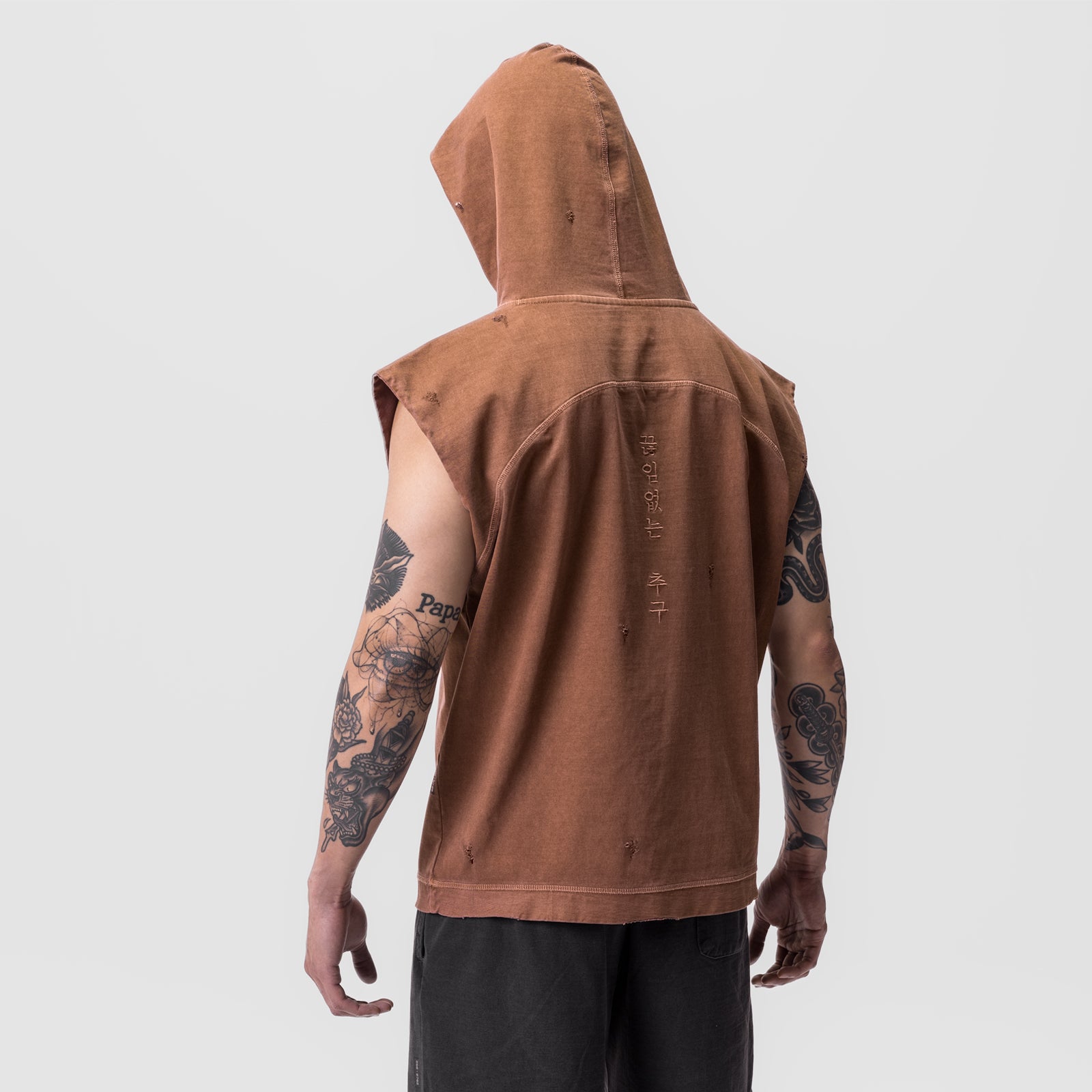Tech Essential Cutoff Hoodie in faded rust worn by model, back view with hood up