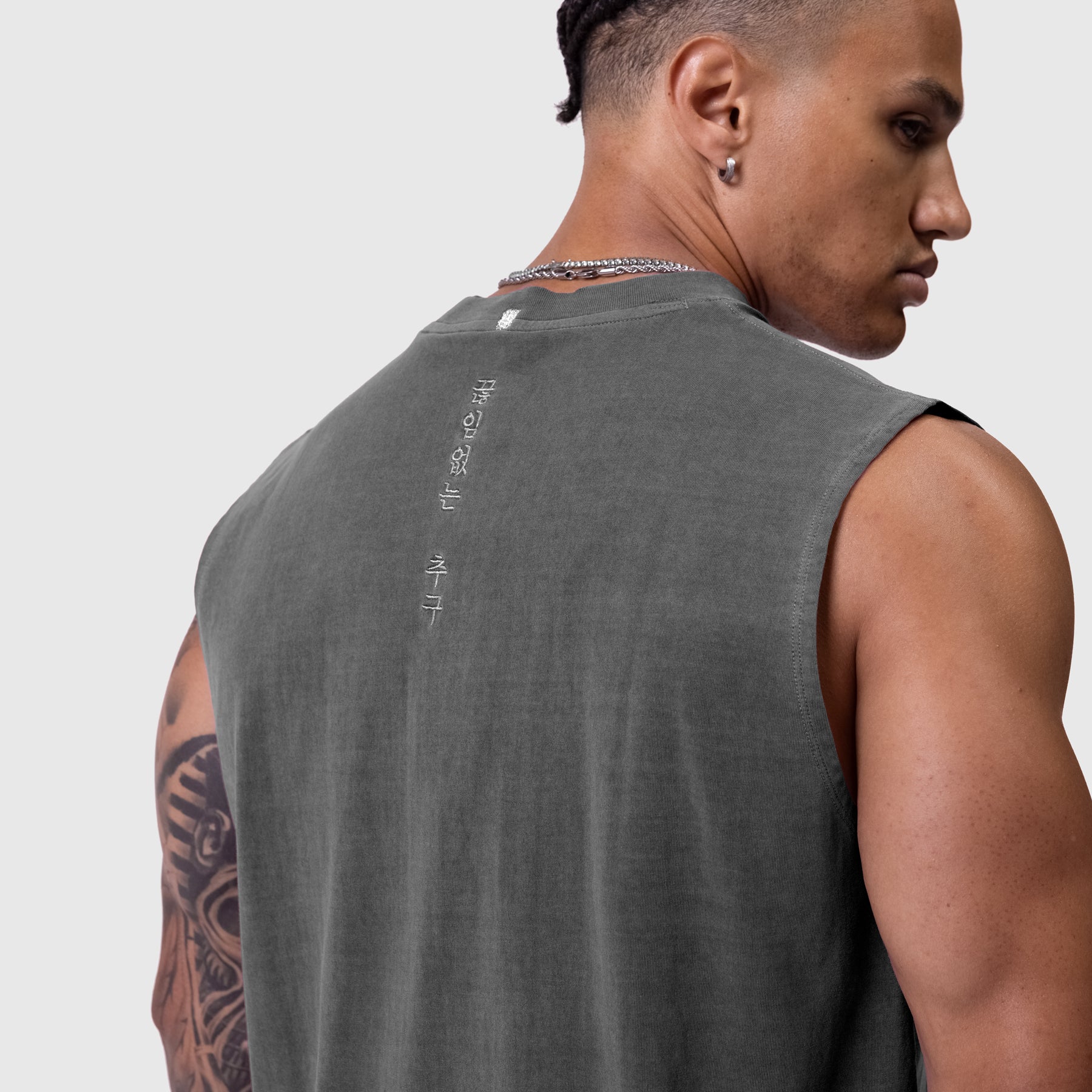 Tech Essential Relaxed Cutoff sleeveless tank in faded grey, back view on model