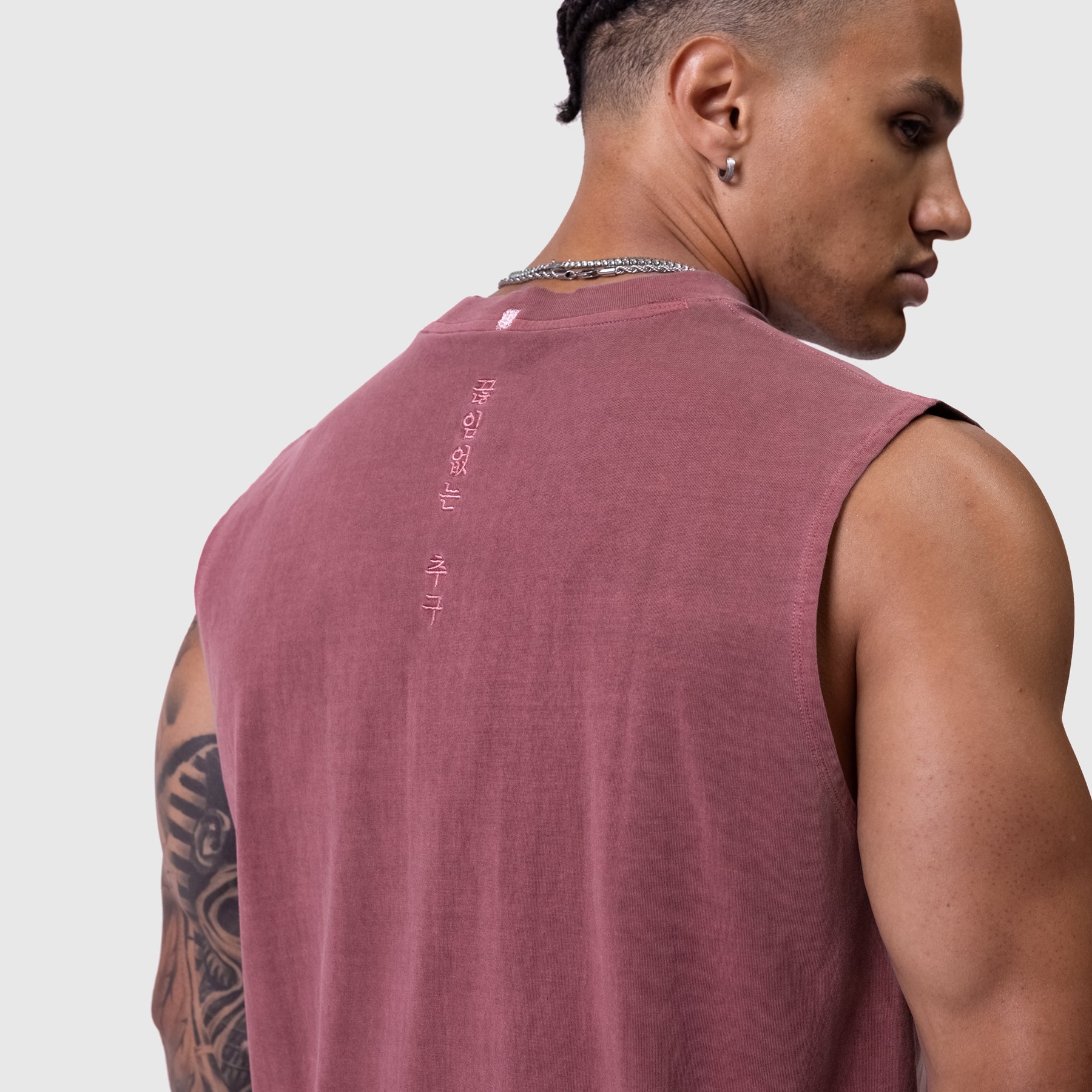 Tech Essential Relaxed Cutoff sleeveless tank in faded crimson, worn by model showing back view