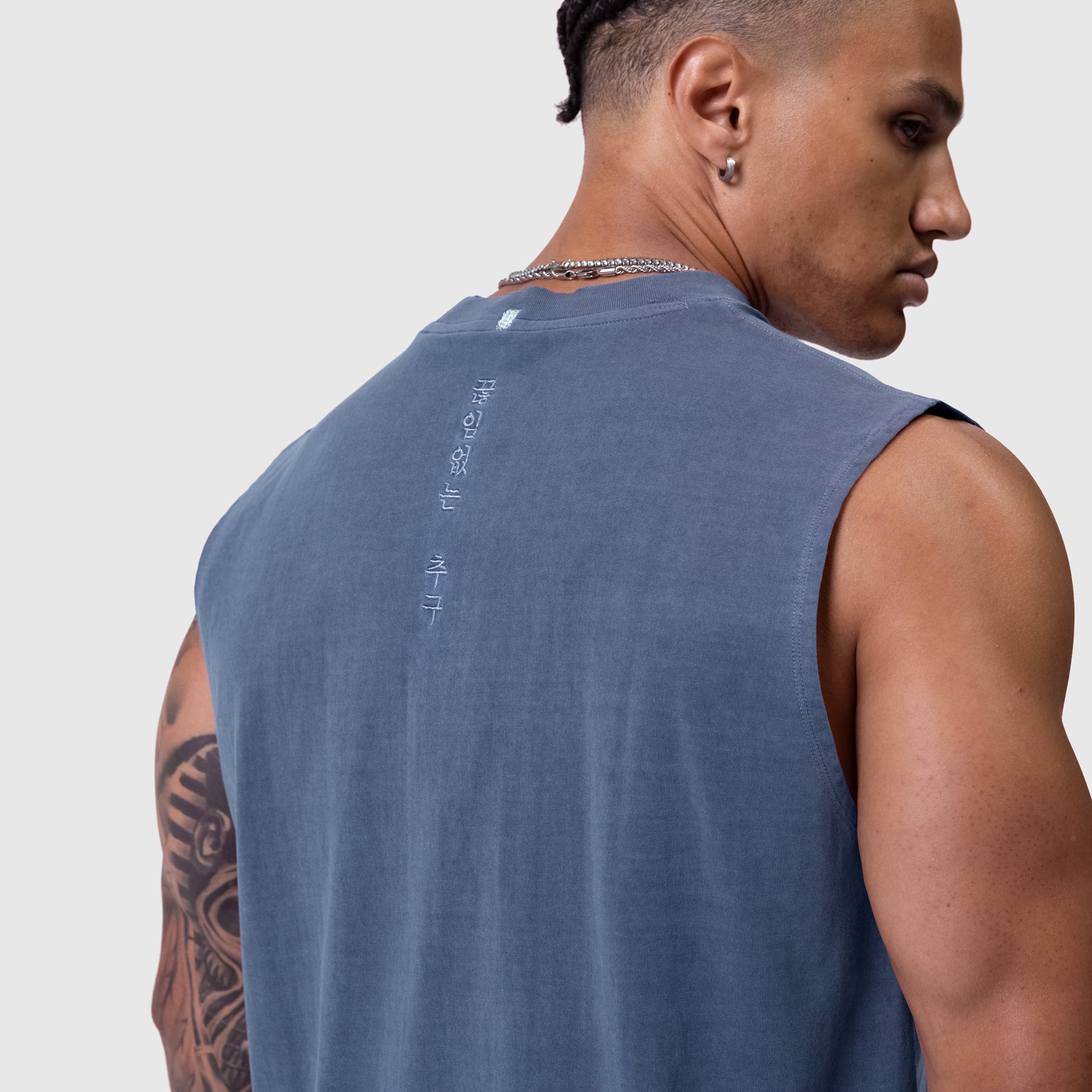 Tech Essential Relaxed Cutoff sleeveless tank in faded navy, back view on model