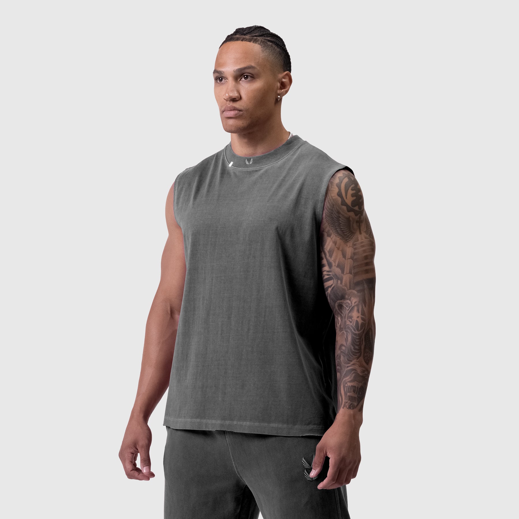 Tech Essential Relaxed Cutoff sleeveless tank in faded grey, worn by model