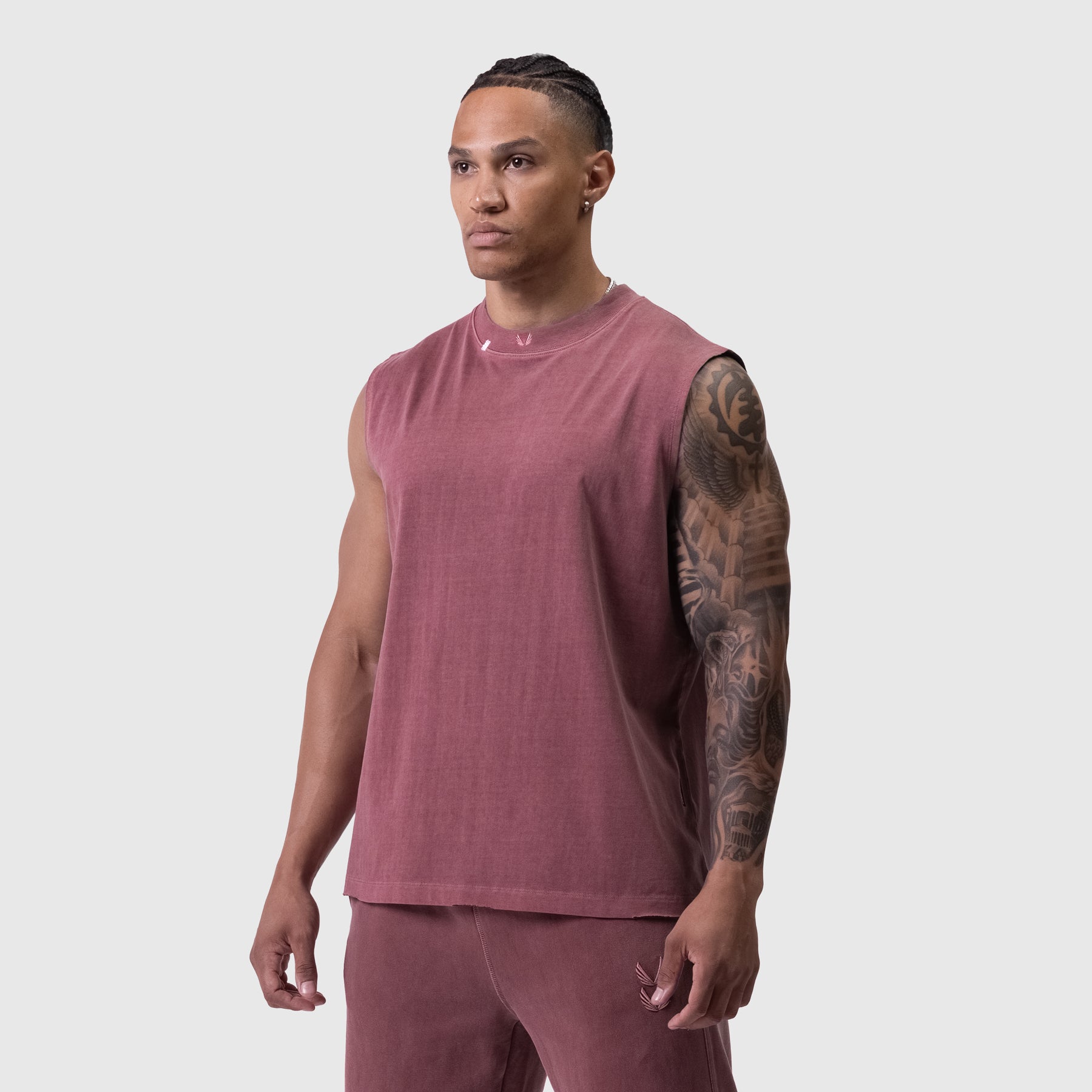 Tech Essential Relaxed Cutoff tank in faded crimson, worn by model, front view