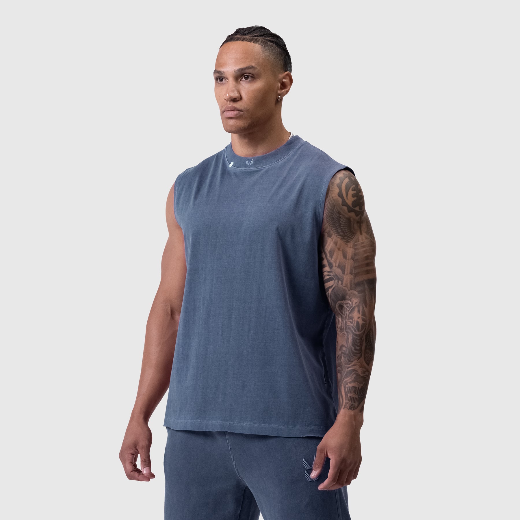 Tech Essential Relaxed Cutoff sleeveless tee in faded navy, worn by model, front view