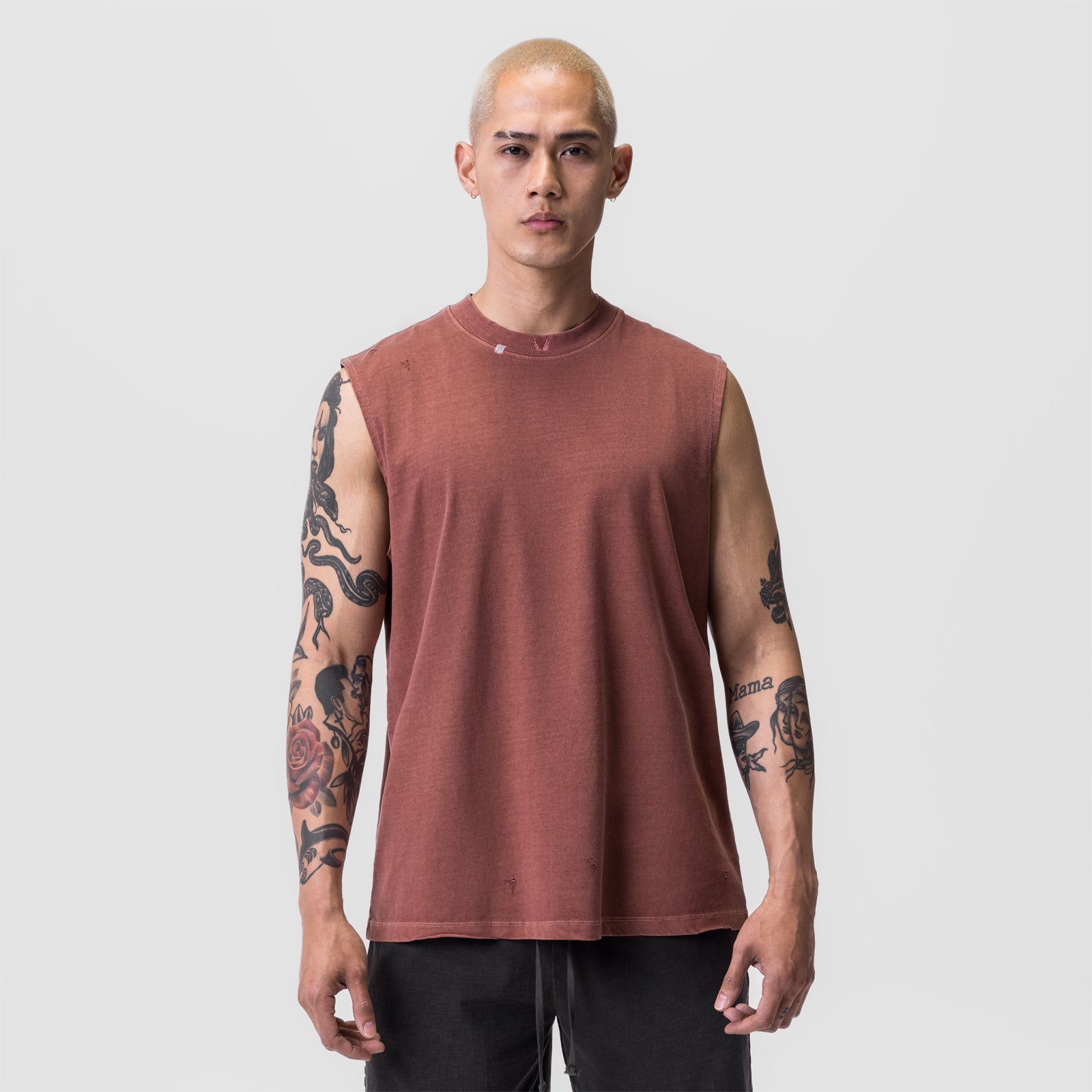 Tech Essential Relaxed Cutoff sleeveless tee in faded brick, worn by model facing camera