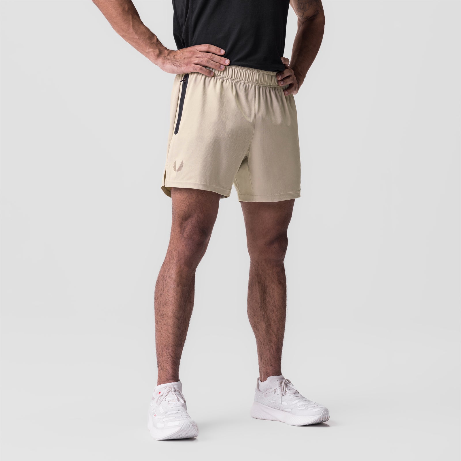 Ultralite 6" Linerless Short in beige, worn by model with hands on hips