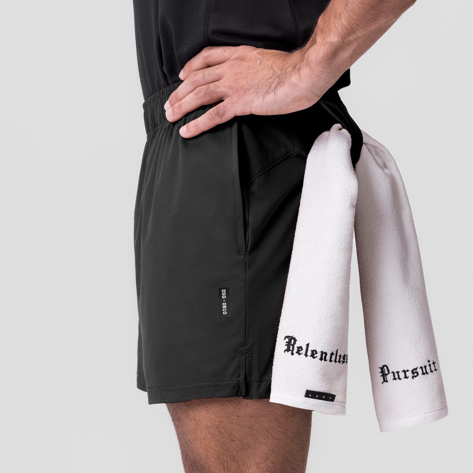 Ultralite 6" Linerless Short in Dusk Black, worn with white towel draped over shoulder
