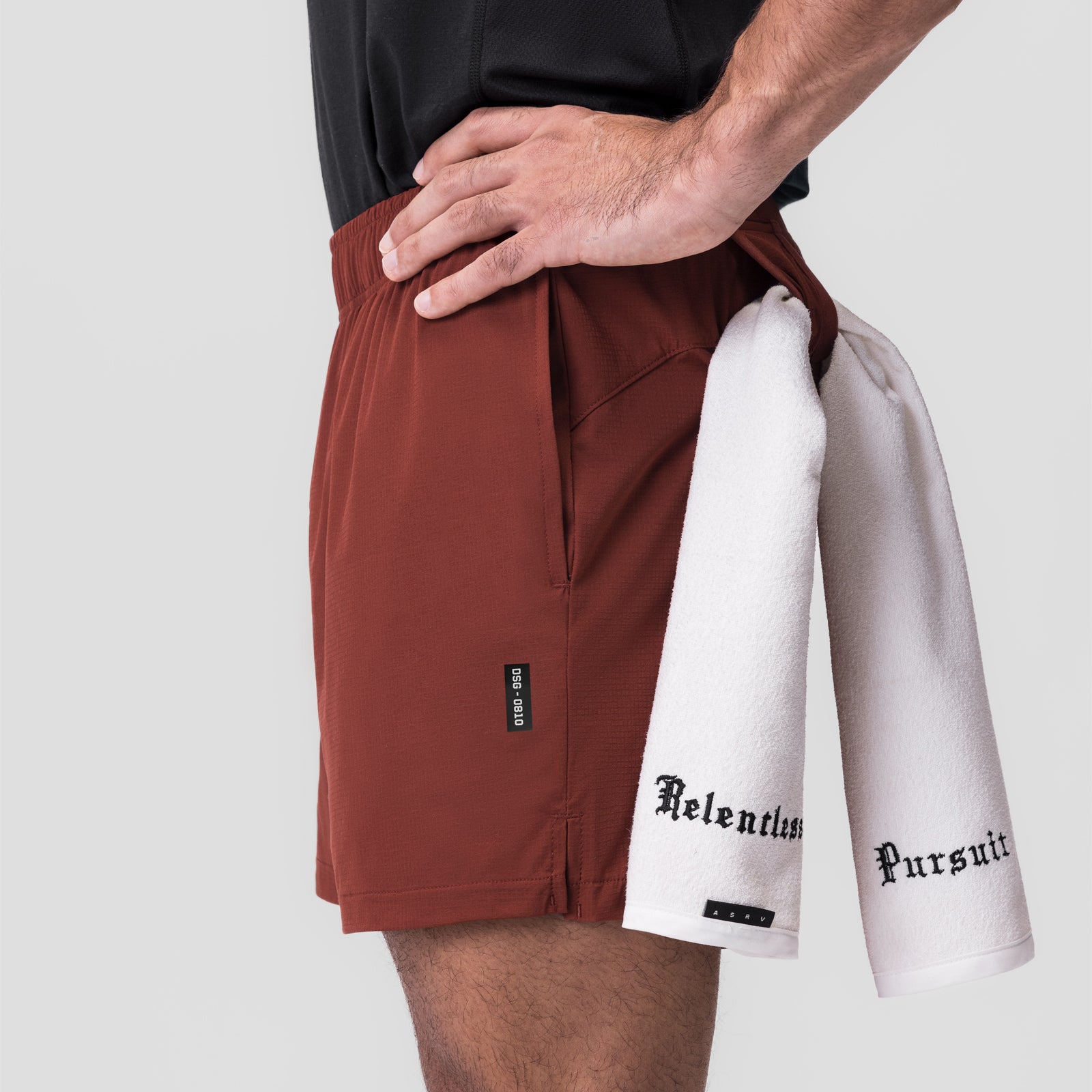0810. Ultralite™ 6" Linerless Short in Brick, worn with white towel, side view
