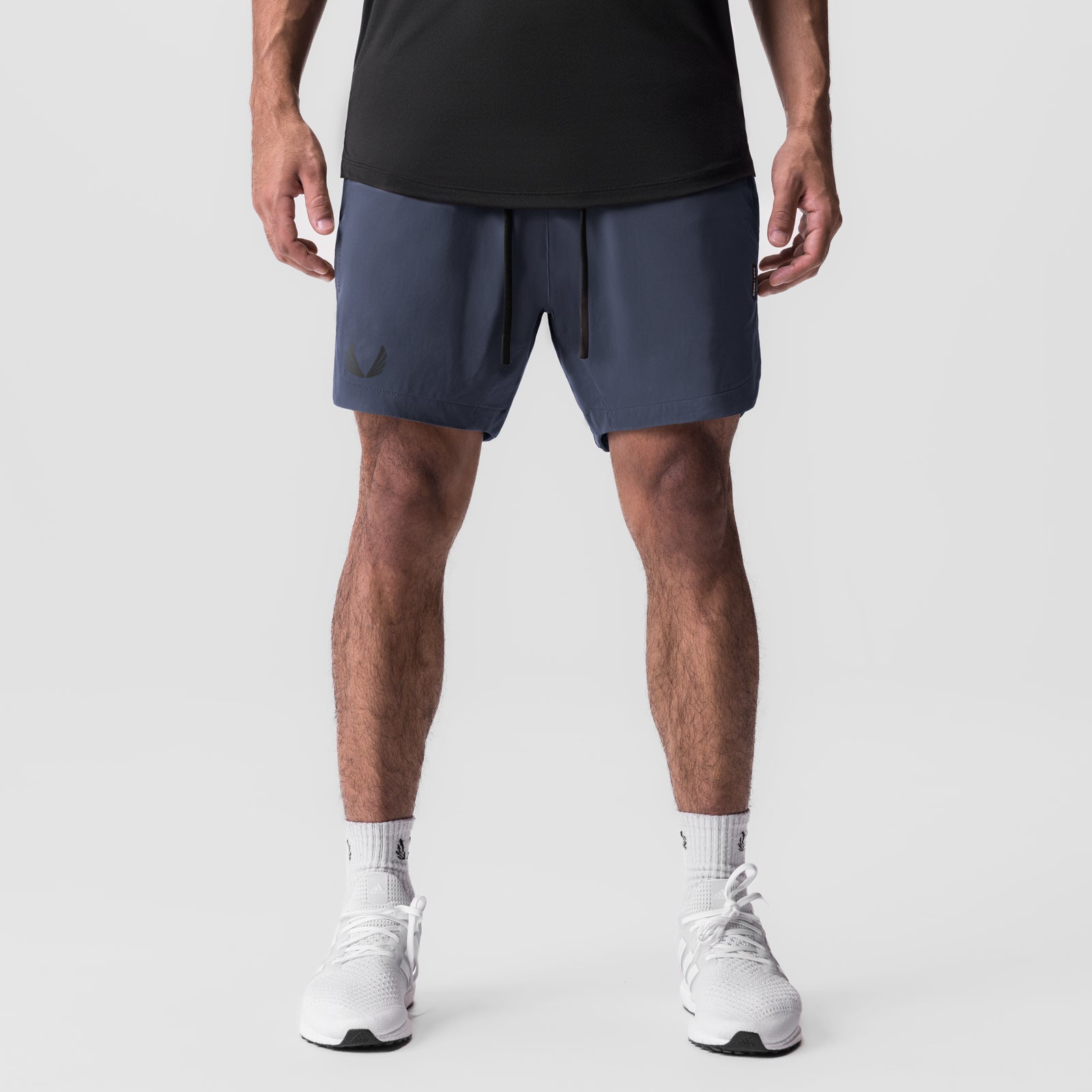 Tetra-Lite 7" Linerless Short in navy, modeled from front on male figure with white sneakers