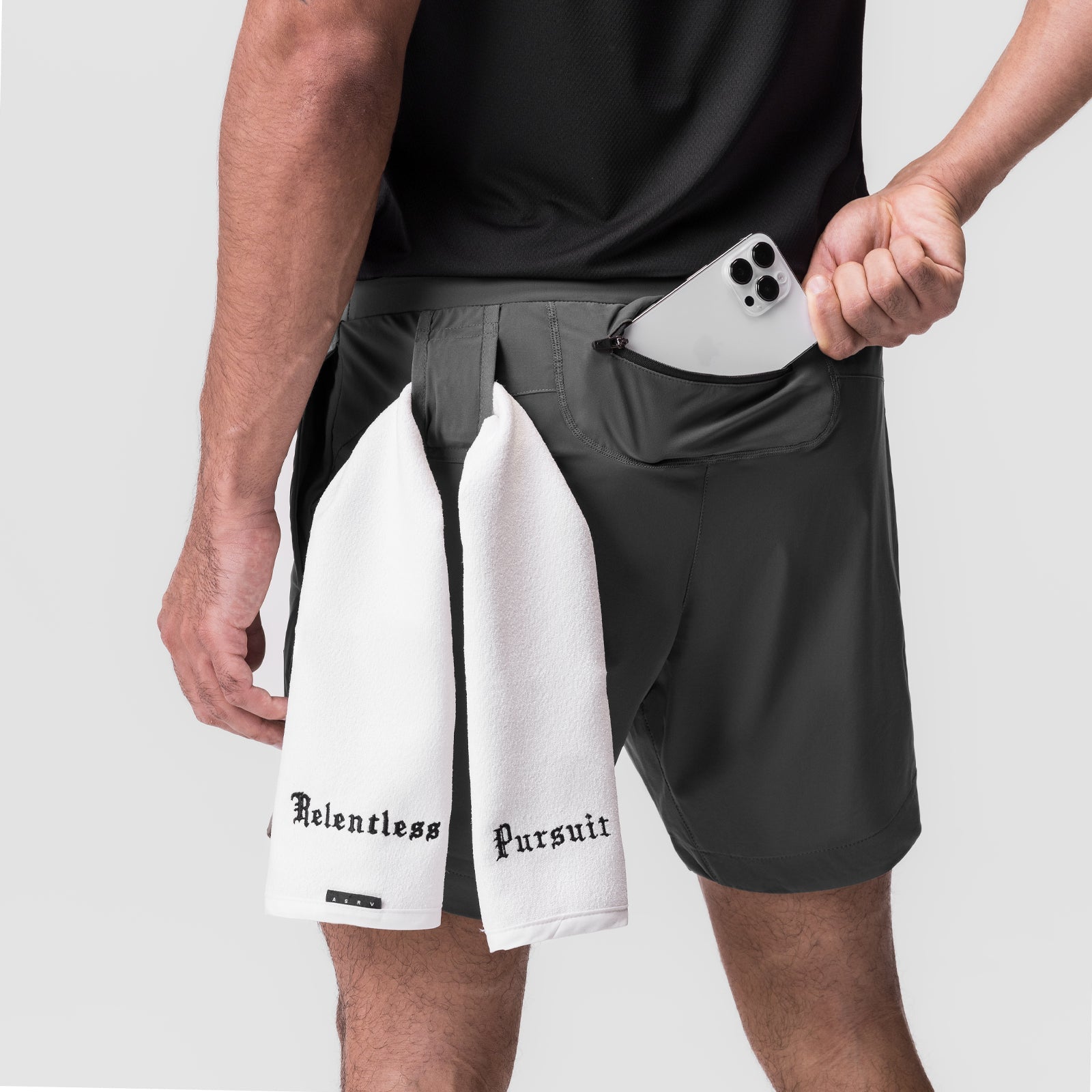 Tetra-Lite 7" Linerless Short in Space Grey worn by model, holding white towel and phone in pocket