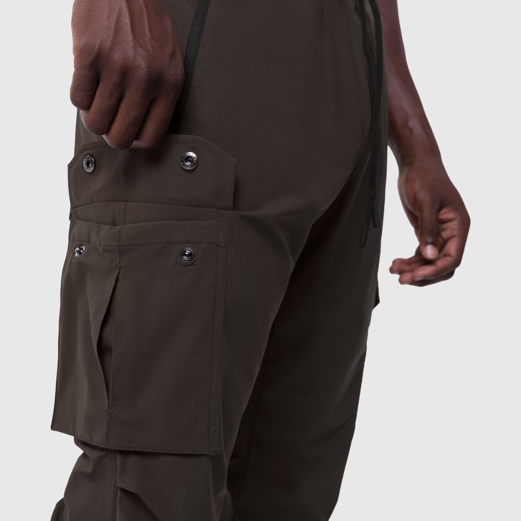 Tetra-Lite Cargo High Rib Jogger in Dark Earth, worn by model showing side cargo pockets