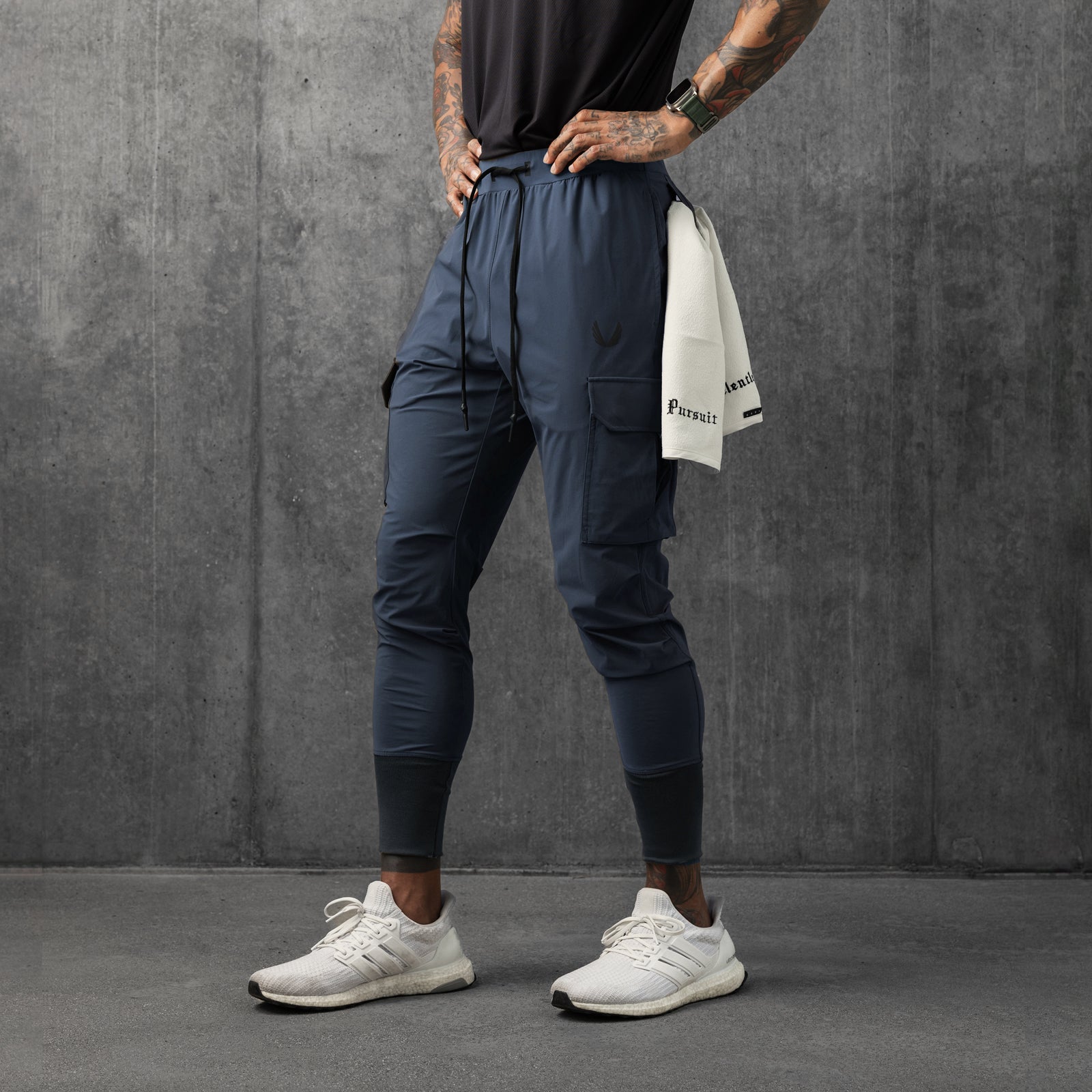 Tetra-Lite Cargo High Rib Jogger in navy, worn by model standing against grey wall