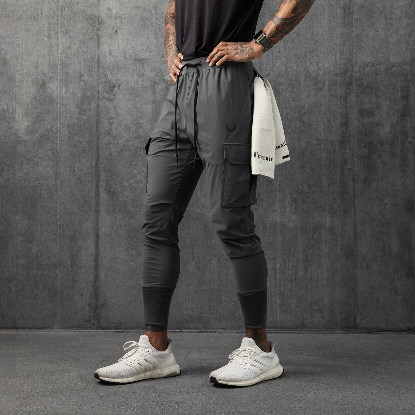 Tetra-Lite Cargo High Rib Jogger in space grey, worn by model standing against concrete wall